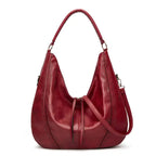 Soft leather hobo bag with perforated detail in red, closeup showcasing rich burgundy color and leather finish.