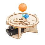 Assembled solar system model with colorful planet balls on rotating wooden gear base powered by motor