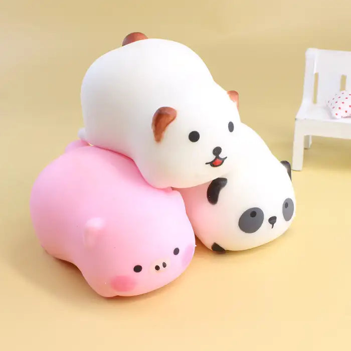 Squeeze toys animal stack featuring pig, bear, and panda in pastel colors on yellow background.