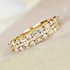 Stackable ring set in gold with baguette and round crystals creating a dazzling layered band design for elegant everyday or event wear