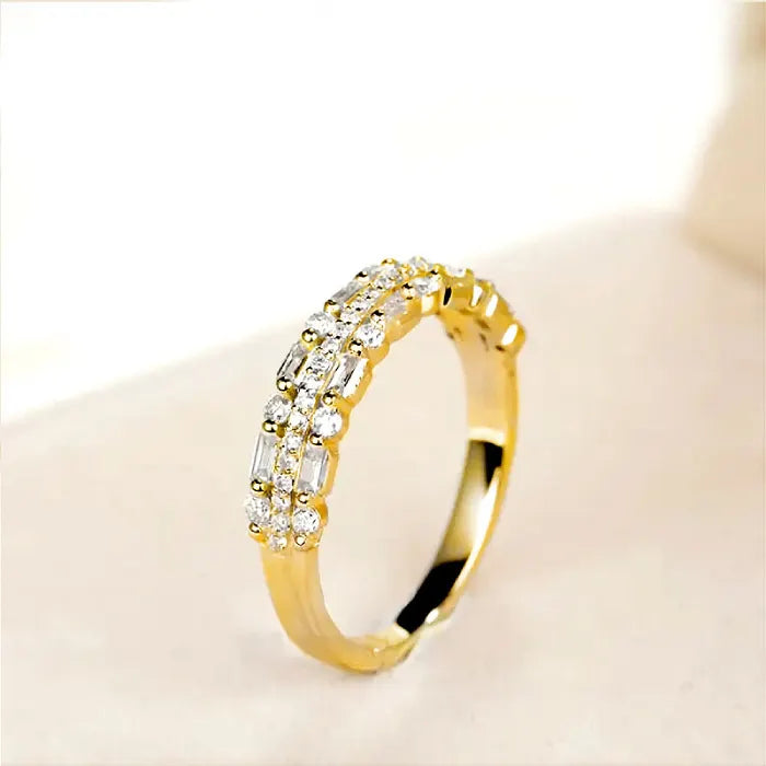 Stackable ring set in gold with round and baguette crystals arranged in layered rows offering elegant sparkling fashion appeal for everyday wear
