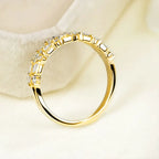 Stackable ring set in gold shown from a side angle with baguette crystals offering a refined sparkling minimalist layered band look for buyers