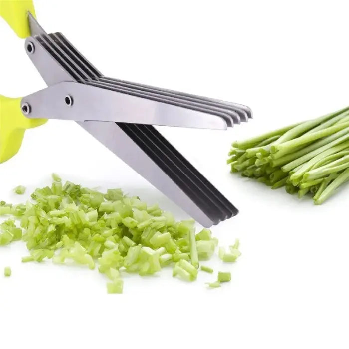 Yellow-handled herb scissors with stainless steel blades mincing green onions on a white background.