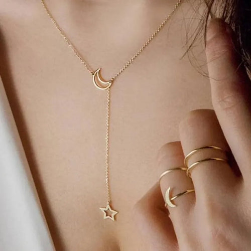 Star Moon Choker delicate gold necklace with moon and star charms worn on model’s neckline