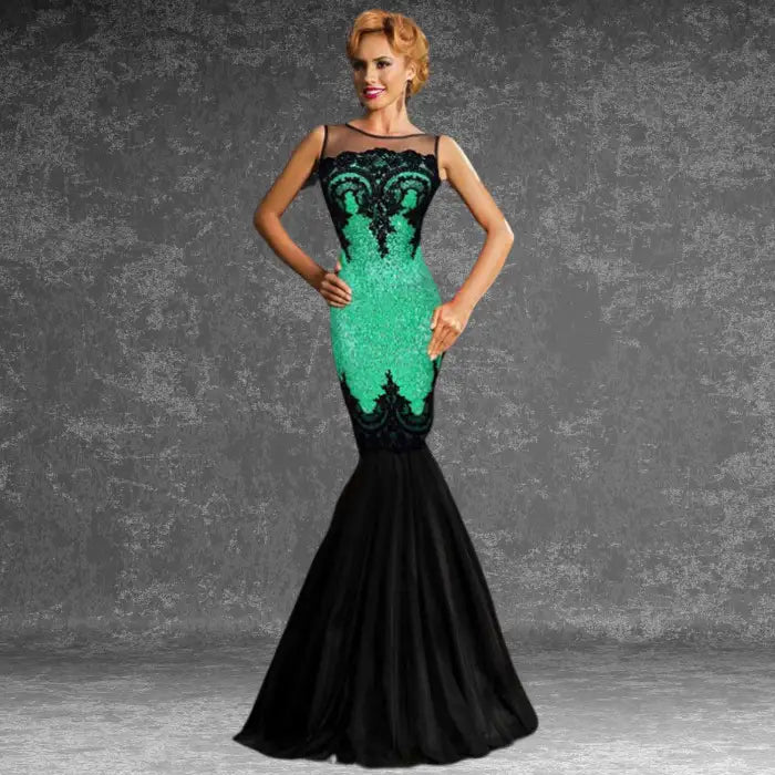 Striking green and black sequin mermaid dress worn by a model, highlighting the illusion neckline and fitted shape. 