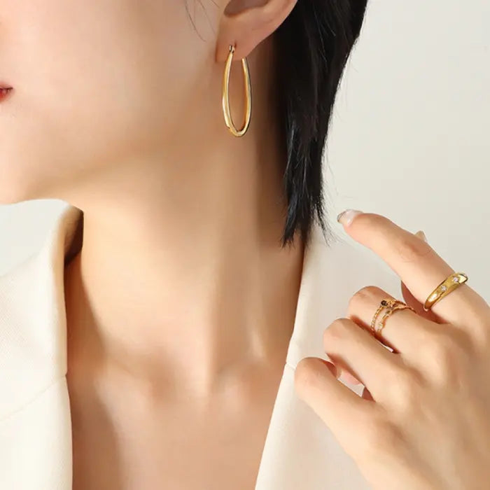 Gold hoop earring and ring combination shown in lifestyle setting