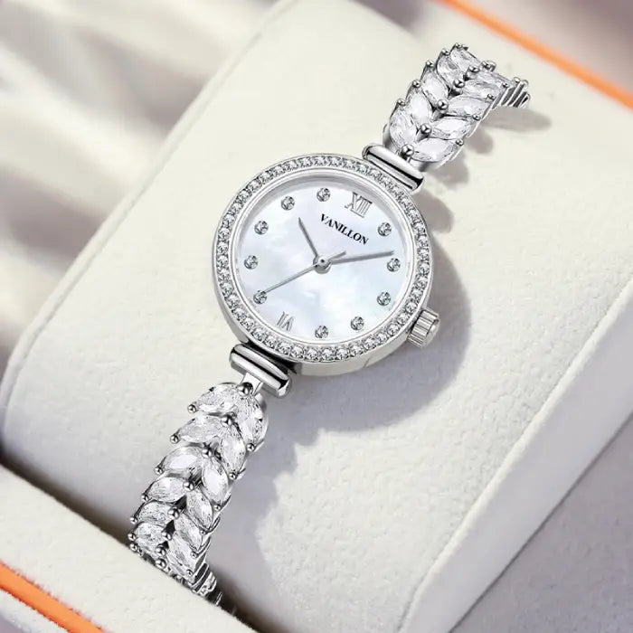 Silver stylish bracelet watch with diamond accents and a mother-of-pearl dial.