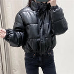 Stylish puffer jacket in black close-up showing snap buttons and high-shine finish