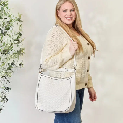 Close-up of a stylish white handbag with woven texture, complementing a casual chic outfit.