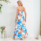 Summer dress featuring back view of blue and brown floral print maxi with spaghetti straps and lightweight fabric for warm weather
