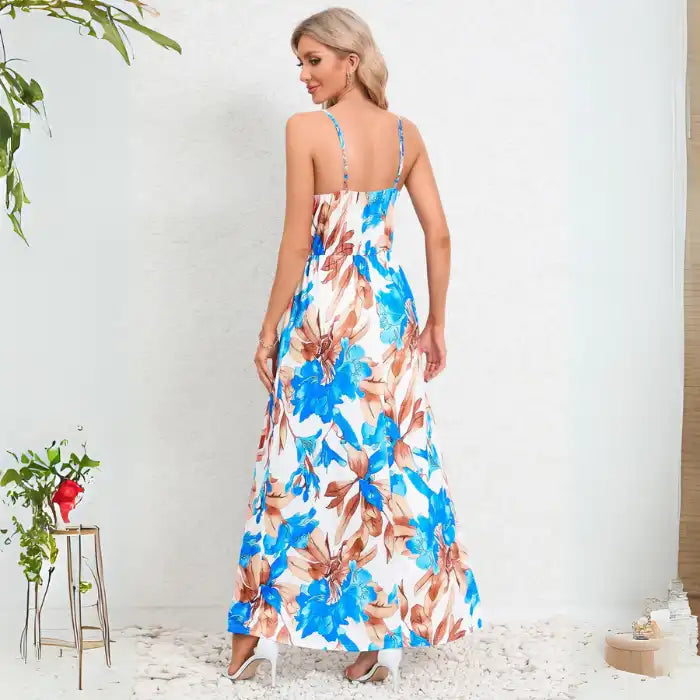 Summer dress featuring back view of blue and brown floral print maxi with spaghetti straps and lightweight fabric for warm weather