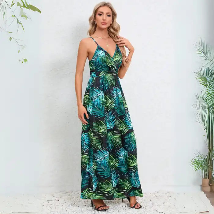 Summer dress showcasing back design of tropical palm print maxi with thin adjustable straps and flowing silhouette