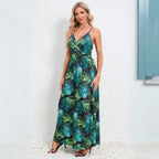 Summer dress in tropical palm print with deep v-neckline and empire waistline, perfect for beach vacations and warm weather occasions