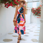 Summer dress with side waist cutout featuring multicolored abstract print in pink, purple and teal, perfect for resort or vacation wear