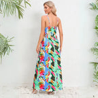 Summer dress featuring vibrant tropical print in a maxi length with adjustable spaghetti straps and v-neck wrap style bodice