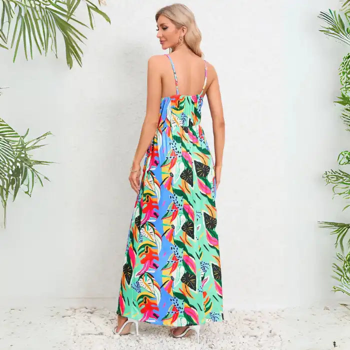 Summer dress featuring vibrant tropical print in a maxi length with adjustable spaghetti straps and v-neck wrap style bodice