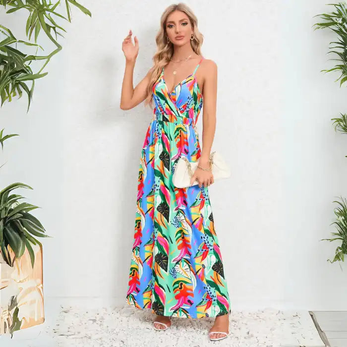 Summer dress in colorful tropical print maxi style paired with white handbag for beach vacation or resort wear