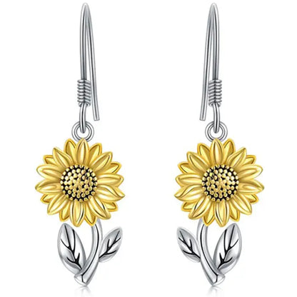 Yellow sunflower dangle earrings with silver leaf details, ideal for floral-inspired jewelry collections.