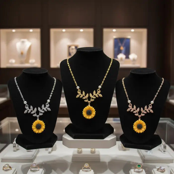 sunflower pendant necklace for women shown in gold silver and rose gold on jewelry stands creating a premium floral accessory display