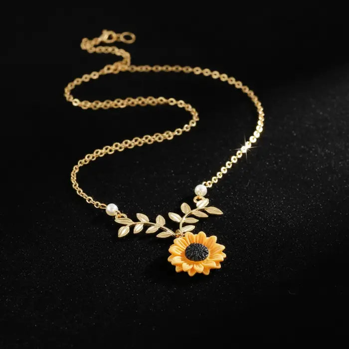 sunflower pendant necklace for women in gold displayed on a dark backdrop featuring sparkling floral details for elegant feminine appeal