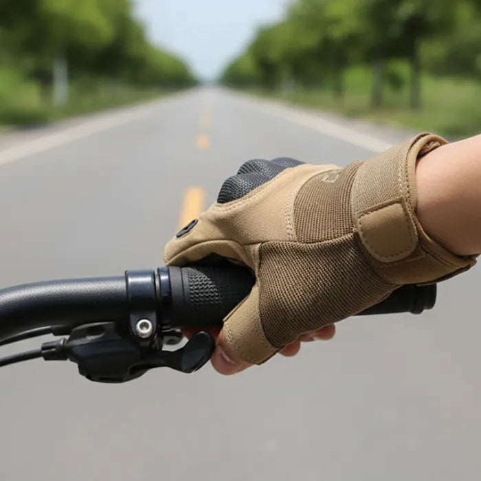Hand wearing a tan glove on a bicycle handlebar with a road and trees in the background