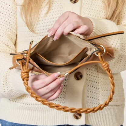 Inside view of camel shoulder bag revealing spacious beige fabric interior with zipper compartment and clean finish