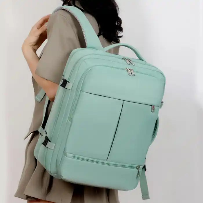 Large capacity teal laptop backpack worn by woman, versatile for business, work, or daily travel.