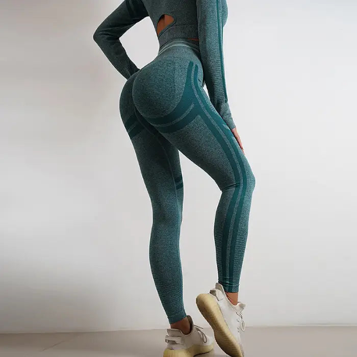  Women's seamless teal activewear set with back cutout top and high-waisted yoga leggings.