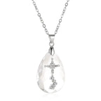 Elegant teardrop-shaped crystal necklace featuring a diamond cross design on a silver chain.