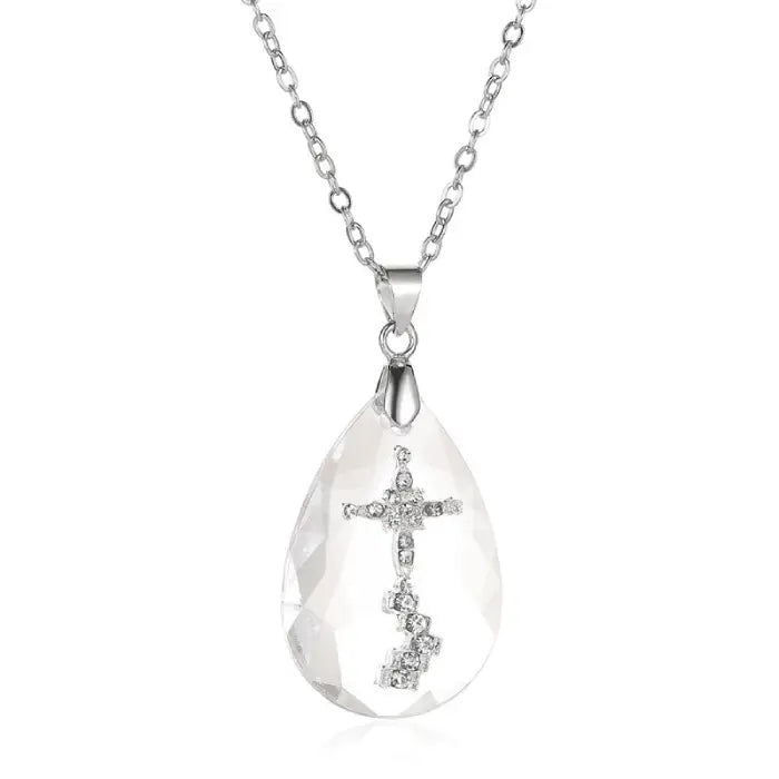 Elegant teardrop-shaped crystal necklace featuring a diamond cross design on a silver chain.