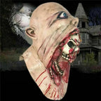 Terrifying-skull-in-mouth-halloween-mask viewed from side with blood-stained teeth and creepy eyeball.