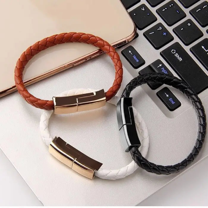 Set of USB charging and data sync bracelets in brown, white, and black leather for stylish portability.