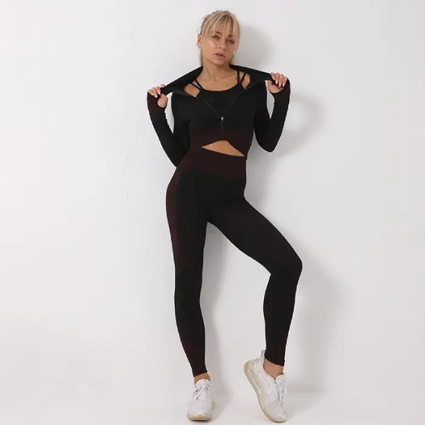 Three-piece seamless yoga set for women in black and maroon with supportive fit and cropped jacket.