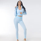 Three-piece seamless yoga set for women in light blue featuring a fitted jacket and contour leggings.