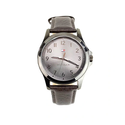 Elegant Tommy Hilfiger analog watch featuring silver dial, brown leather strap and stainless steel case