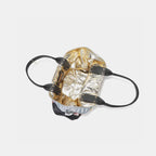 Open top view of tote bag showing metallic gold interior lining and black leather handles