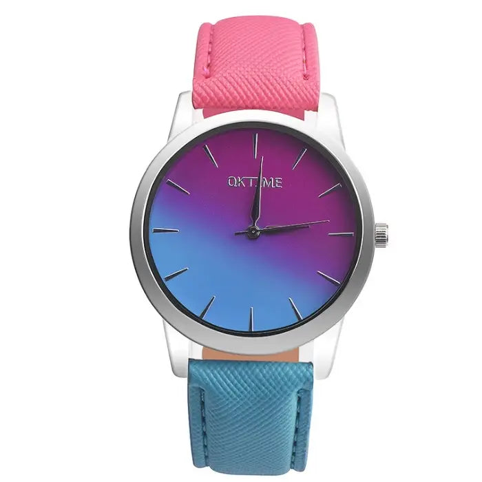 Modern women's watch with blue to purple gradient dial, silver case, and dual-tone pink and blue leather strap