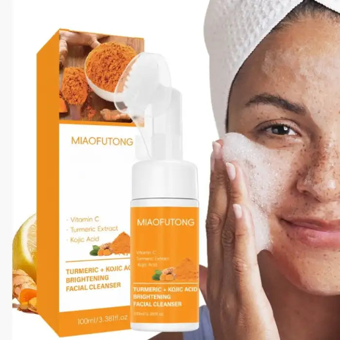 Woman applying turmeric skin cleanser foam to face beside branded product packaging.