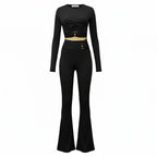two piece set black ribbed crop top and flared pants with gold accent hardware creating a timeless modern look