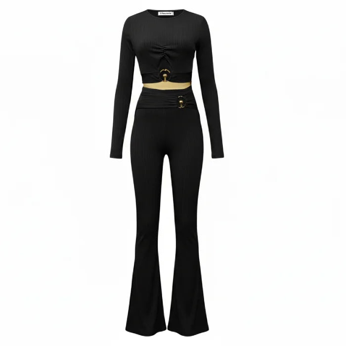 two piece set black ribbed crop top and flared pants with gold accent hardware creating a timeless modern look