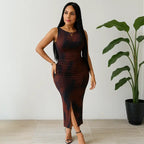 Brown tye dye form-fitting dress with a sleeveless design, side slit, and ruched detailing for a flattering silhouette.