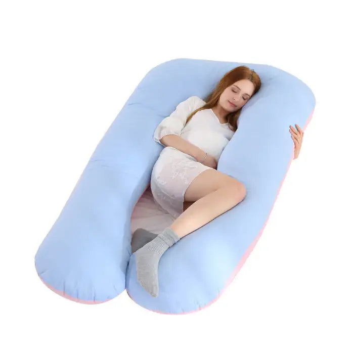 Light blue U-shape pregnancy pillow with soft pink edges supports comfortable maternity sleep.
