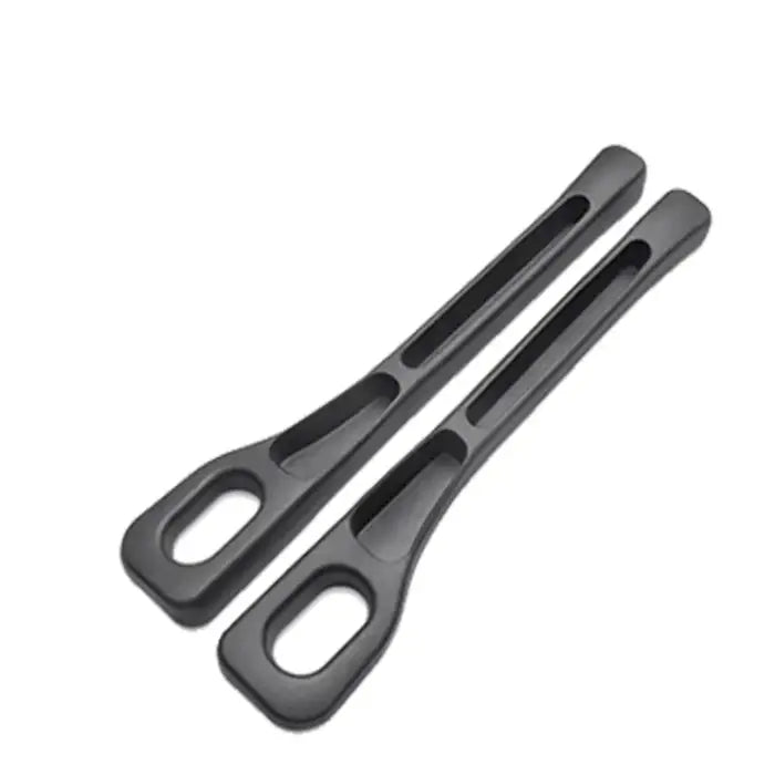 Pair of black plastic car seat gap fillers featuring ergonomic design with storage slots