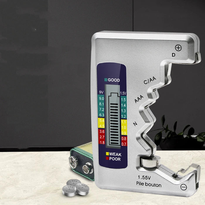 Digital battery tester with a multi-color display, showing good-to-poor battery levels, alongside button and coin cell batteries.