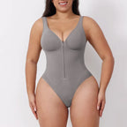 V neck shapewear bodysuit in grey shown on a model, highlighting sculpting compression, zipper front, and supportive shaping for daily wear