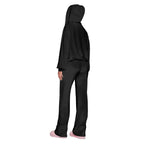 Velour tracksuit back view in black highlighting a draped hood and relaxed fit pants for smooth everyday comfort