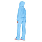 Velour tracksuit back view in sky blue highlighting a draped hoodie and flowing pants for smooth comfort and relaxed wear