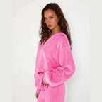 Velour tracksuit in bright pink close-up highlighting soft sheen hoodie fabric for cozy loungewear and giftable style
