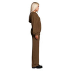 Velour tracksuit in chocolate brown displayed from the side featuring a loose hoodie and wide leg pants for cozy comfort