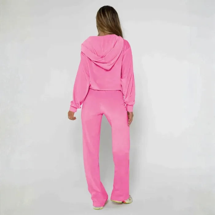 Velour tracksuit in pink shown from the back with a soft hooded jacket and relaxed pants for everyday comfort and style